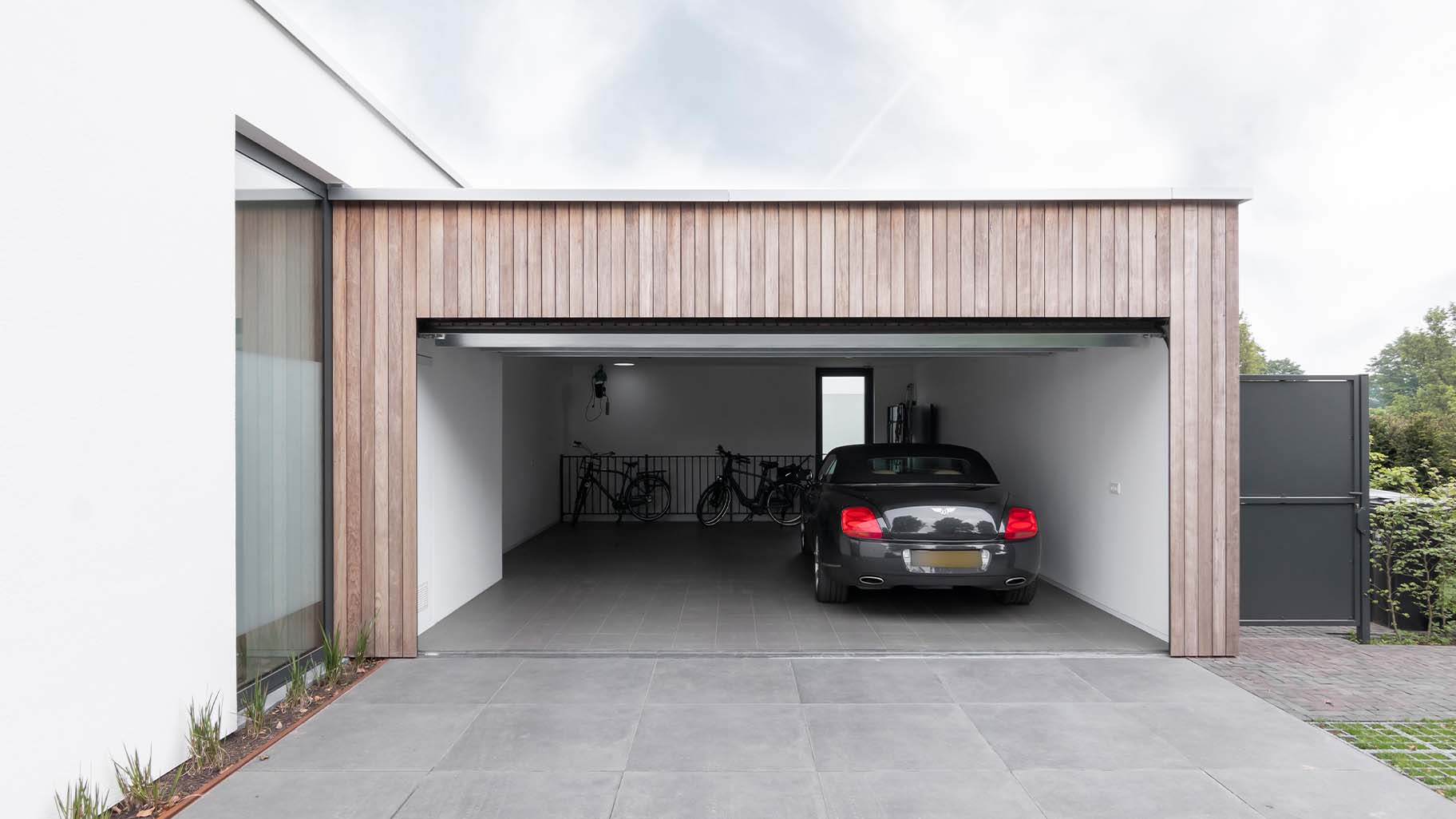 Luxe houten garagedeur die gelijk met de gevel is geplaatst