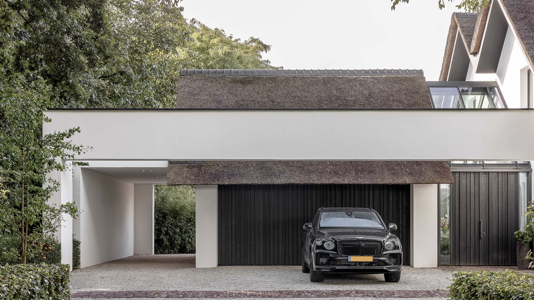 Donkere houten garagedeur van red cedar hout gerealiseerd door different doors